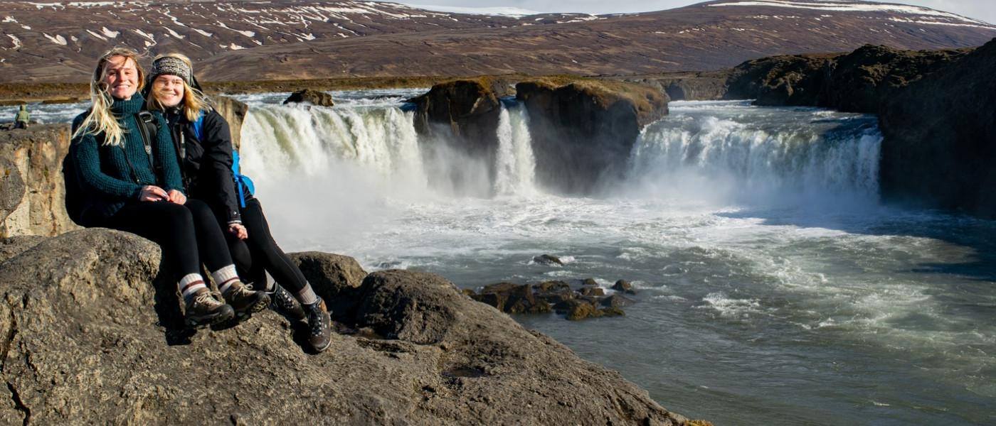 Students near a waterfall in Iceland during Travel Course